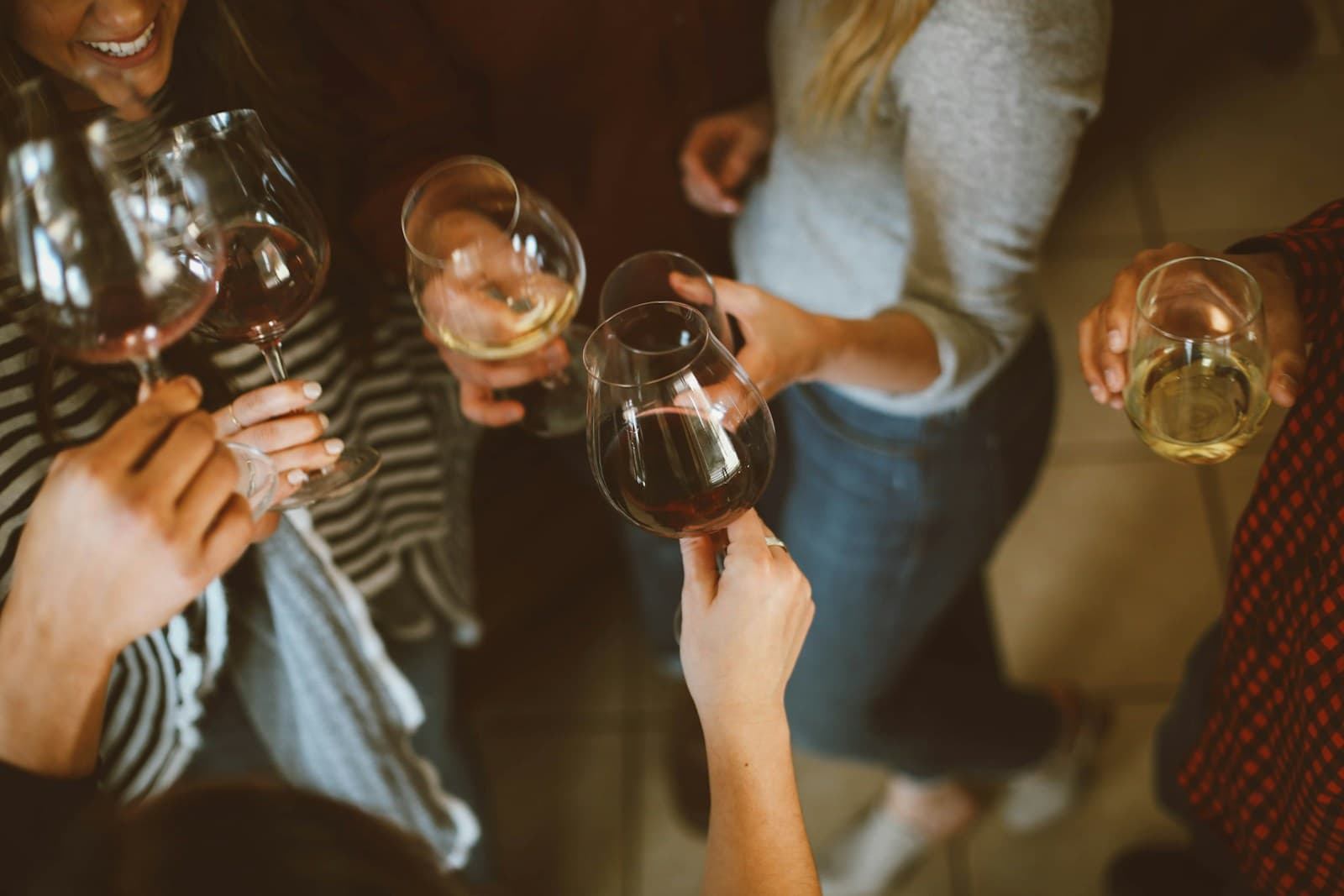 Friends toasting wine glasses at a private gathering
